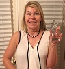 Linda holding award